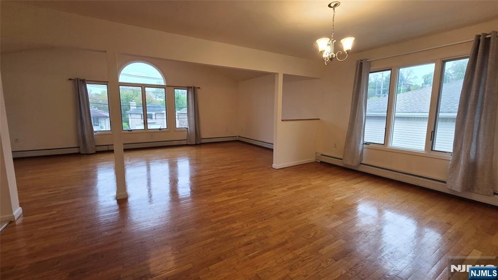 755 Edgewater Avenue, Unit 2 Ridgefield, NJ 07657 - Photo 2 of 13 a view of empty room with wooden floor and fan