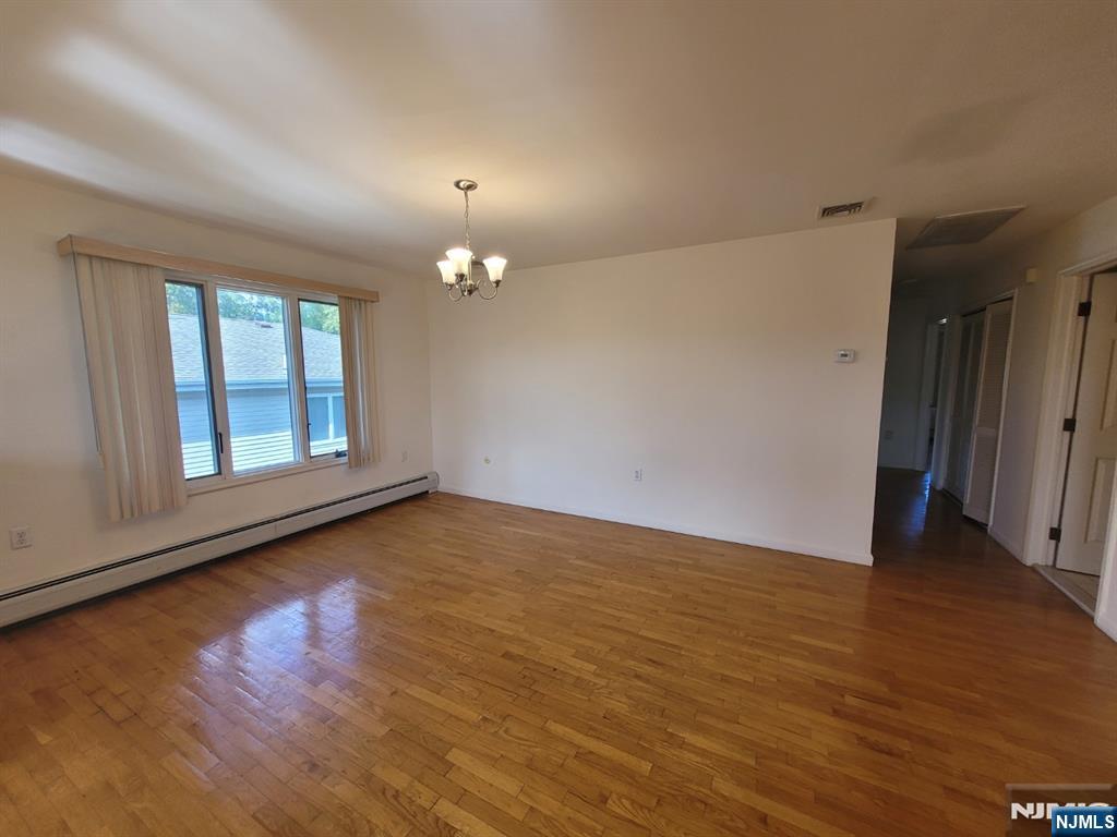 755 Edgewater Avenue, Unit 2 Ridgefield, NJ 07657 - Photo 5 of 13 an empty room with wooden floor and windows