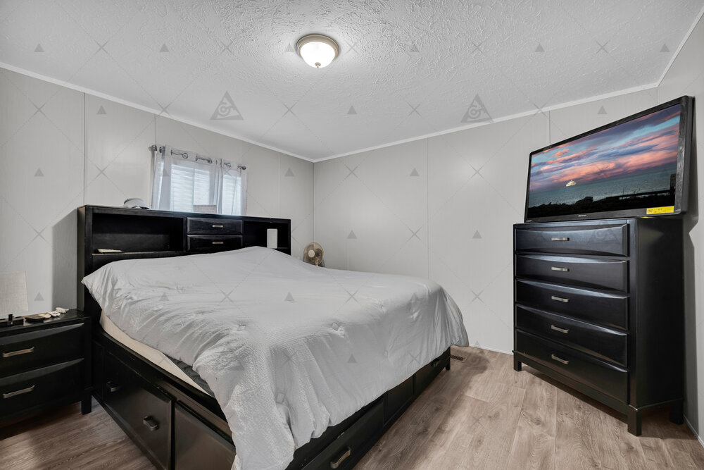 107 Clearwater Shores Road Fair Play, SC 29643 - Photo 13 of 23 Smooth wood-plank flooring pairs with neutral-toned walls under a textured ceiling in this bedroom.