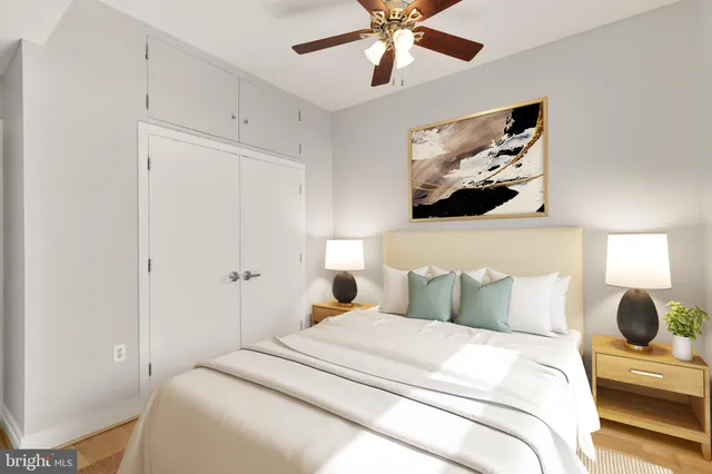 a bedroom with a bed and painting on the wall