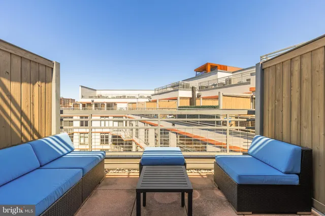 a view of living room with furniture and a floor to ceiling window