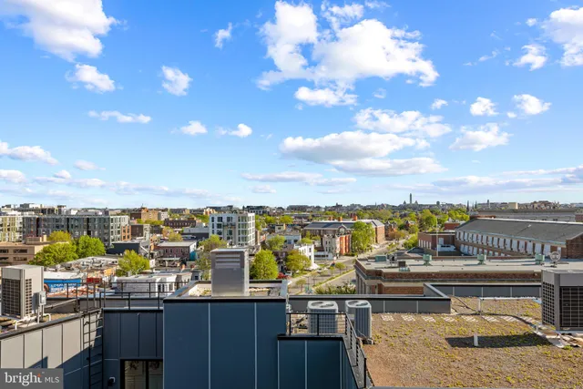 a view of a terrace with lawn chairs