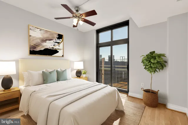 a bedroom with a large bed and a chandelier