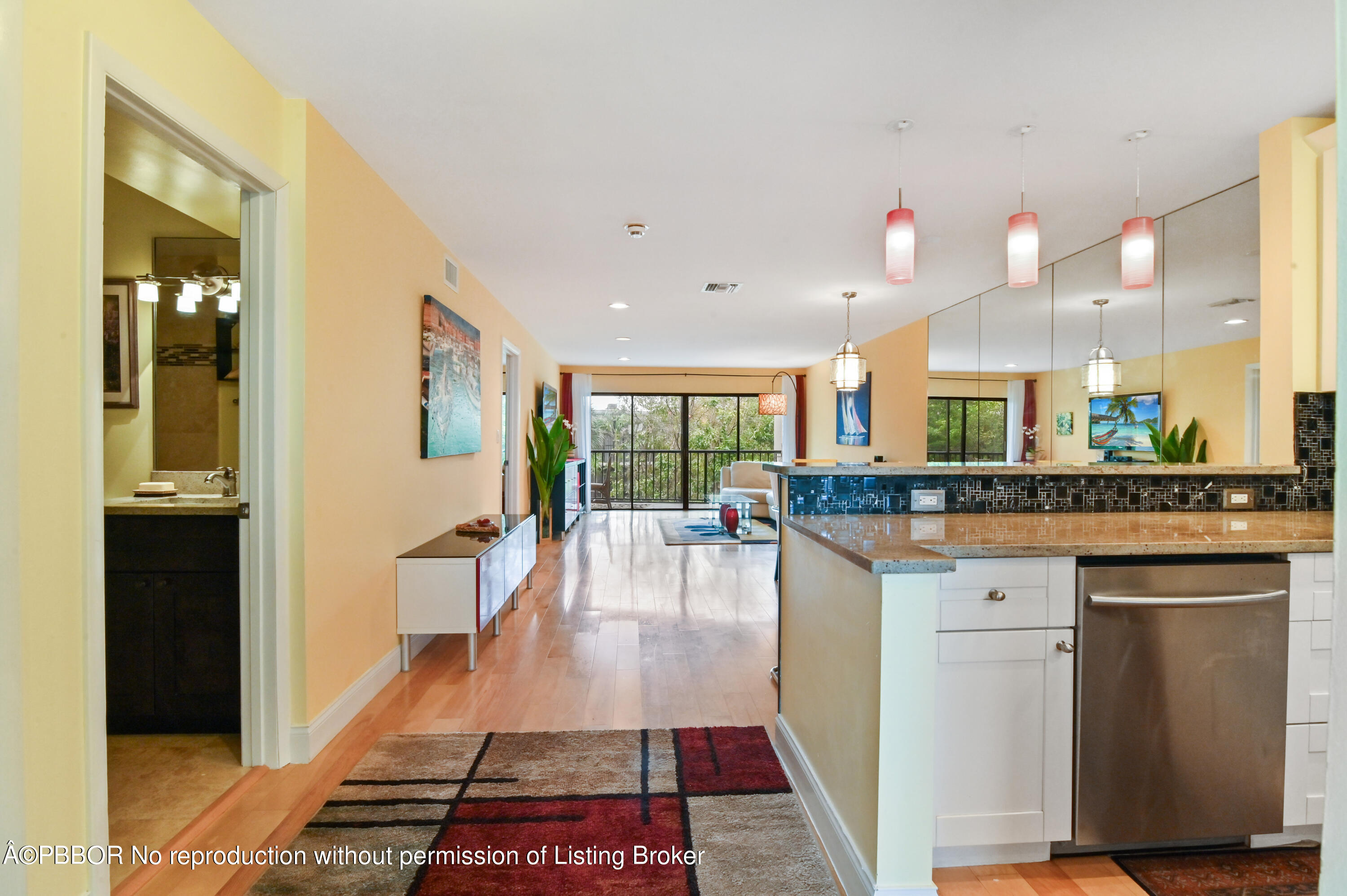 a dining hall with stainless steel appliances granite countertop a refrigerator and a stove