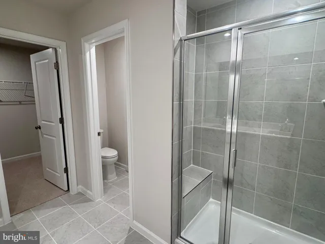 a bathroom with a shower and a toilet