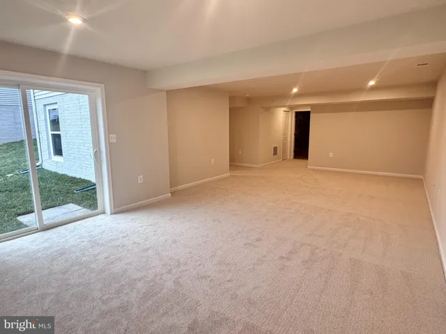 a view of an empty room with glass door