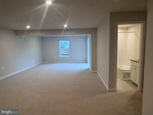 a view of an empty room and a bathroom