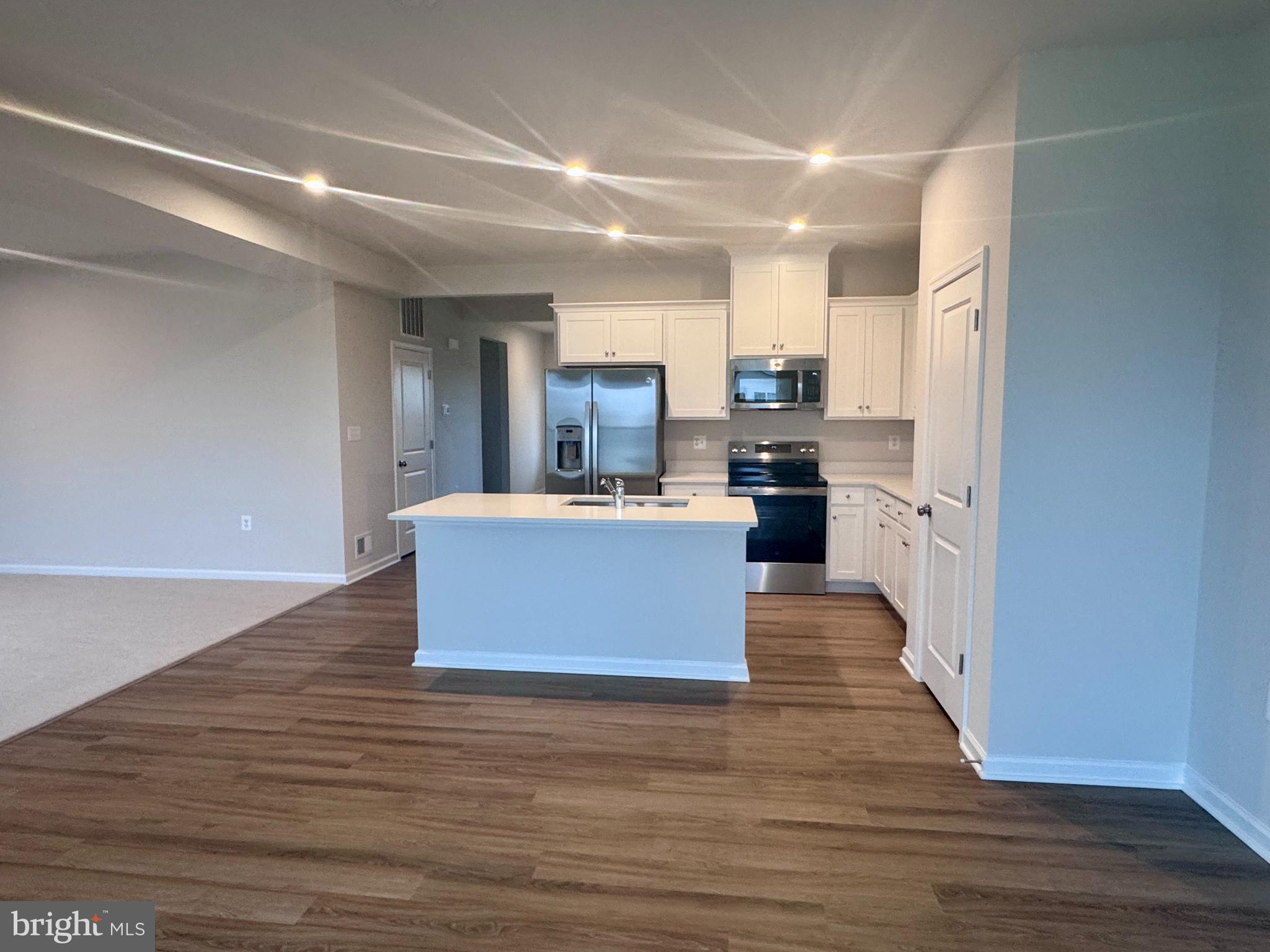 37 Taft Avenue Ranson, WV 25438 - Photo 4 of 18 a large kitchen with stainless steel appliances a large counter top a stove and a refrigerator