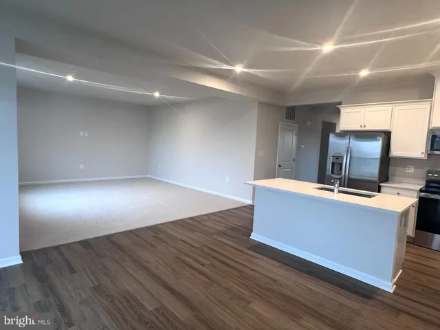 a room with wooden floor and furniture