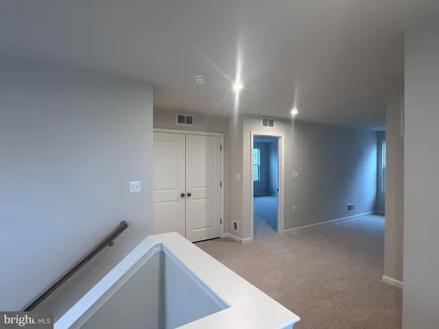 a view of hallway with cabinets