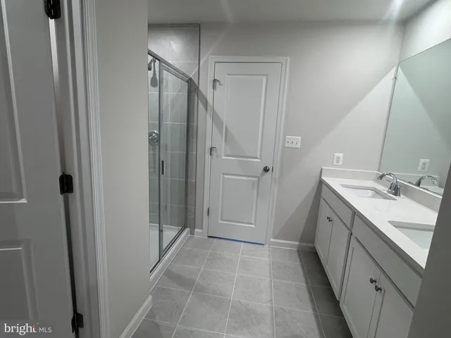 a bathroom with a double vanity sink a toilet and a mirror