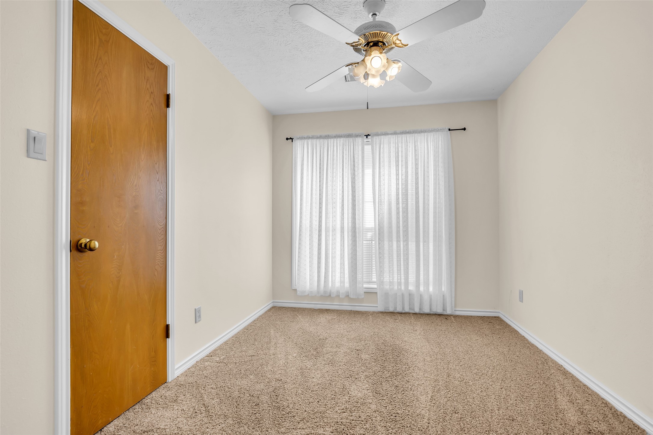 7 Lazy Spring Trinity, TX 75862 - Photo 18 of 25 Spacious bedroom featuring plush carpeting, a modern ceiling fan, and closet space.