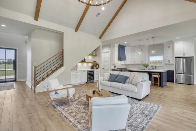a living room with furniture and kitchen view
