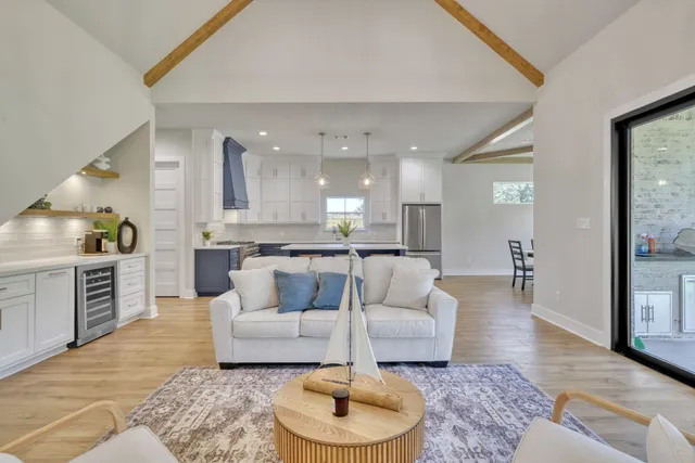 a living room with furniture and a kitchen