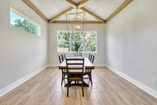 a view of a room with furniture wooden floor and a window