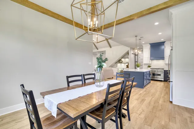 a dining room with furniture and wooden floor
