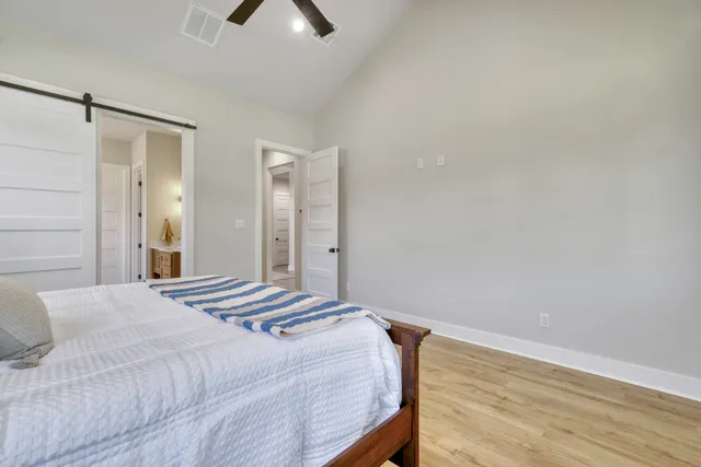 a bedroom with a bed and a chandelier