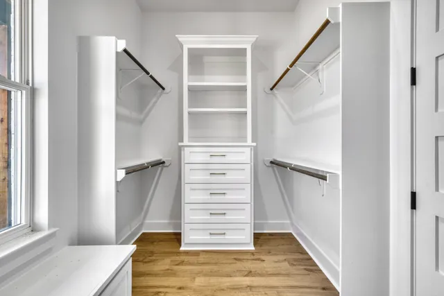 a view of walk in closet with empty racks