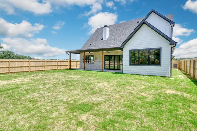 a view of a house with garden and deck