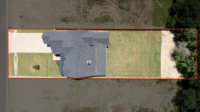 an aerial view of a residential building with an outdoor space