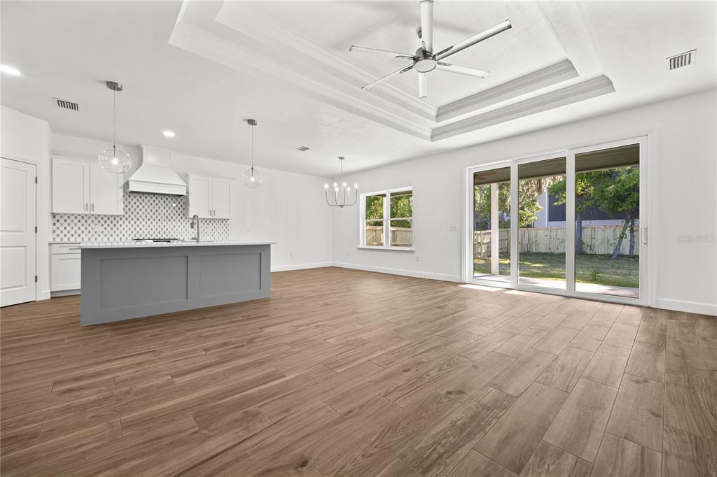 1086 Southwest 67th Drive Gainesville, FL 32607 - Photo 15 of 37 a view of an empty room with wooden floor and a window