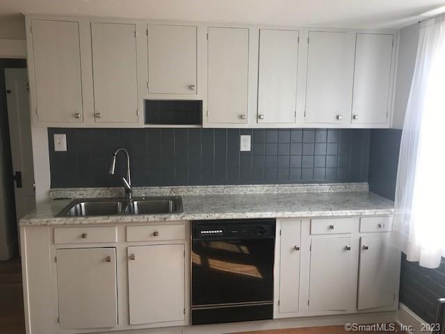 19 Greenfield Avenue Ridgefield, CT 06877 - Photo 7 of 28 a kitchen with white cabinets and sink