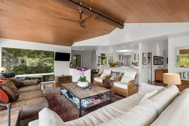 a large kitchen with lots of counter space and windows