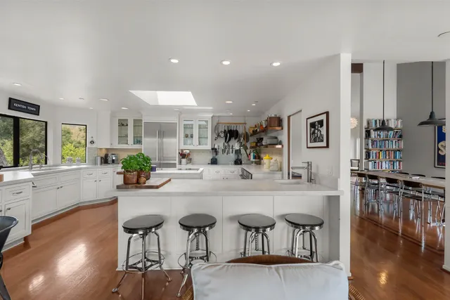 a kitchen with counter top space and wooden floor