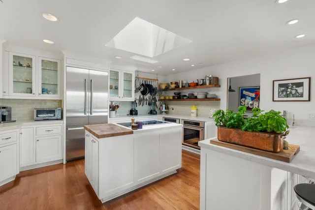 a kitchen that has a sink and a stove in it