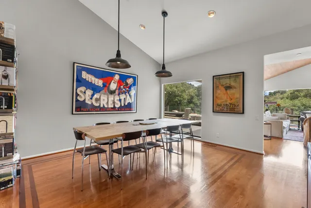 a view of a dining room with furniture and a bookshelf
