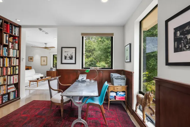 a view of living room filled with furniture and book shelf