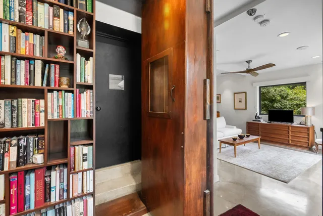 a living room with lots of books