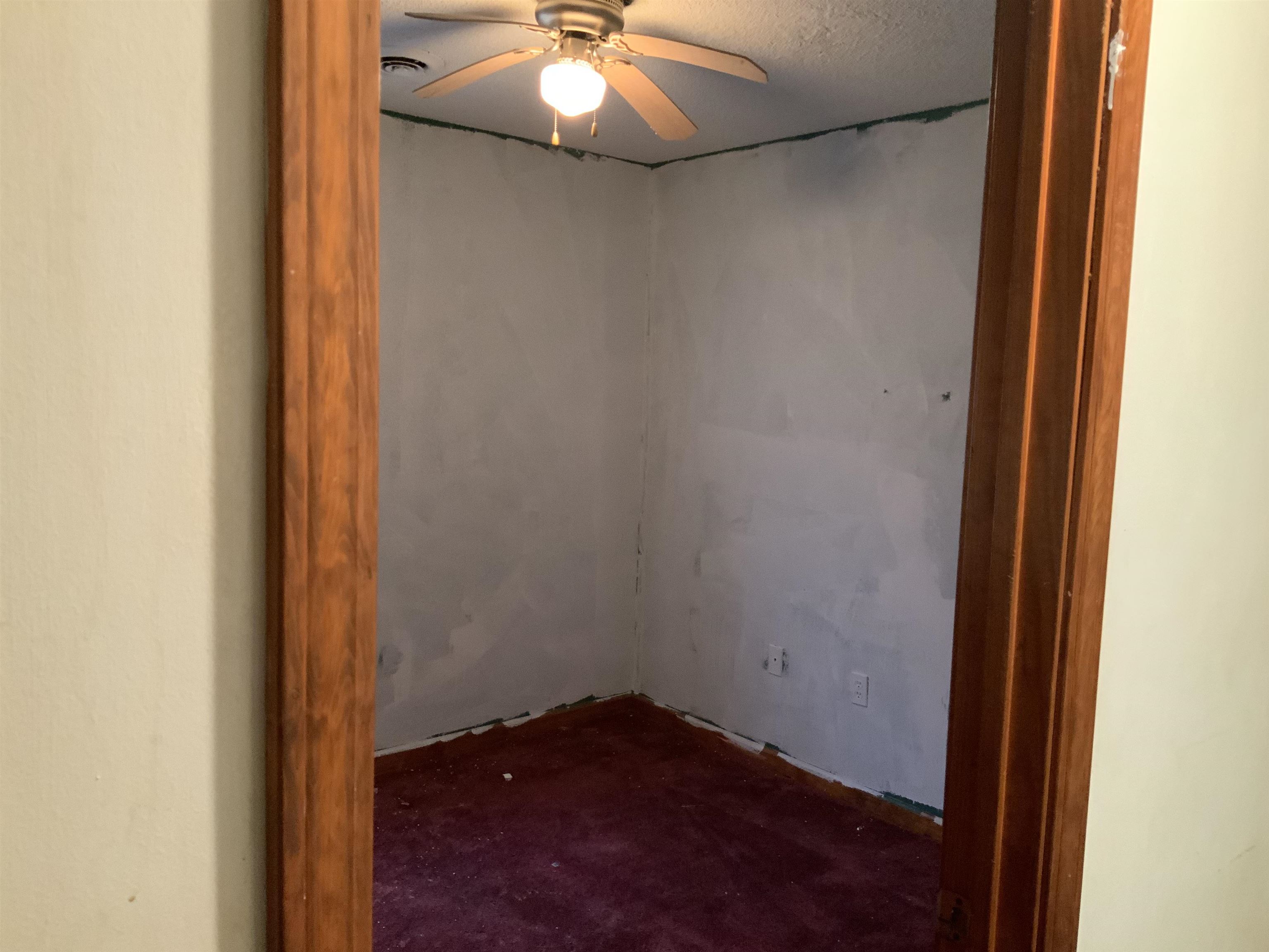 1860 Highway 59 Covington, TN 38019 - Photo 6 of 32 a view of an empty room with a chandelier fan and closet