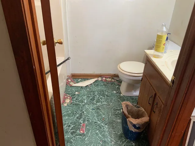 a white toilet sitting next to a bathroom sink