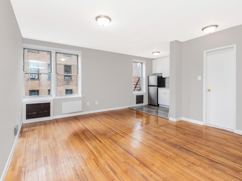 6535 Broadway, Unit 4B Bronx, NY 10471 - Photo 8 of 11 Unfurnished living room with light wood-style floors, a fireplace, and baseboards