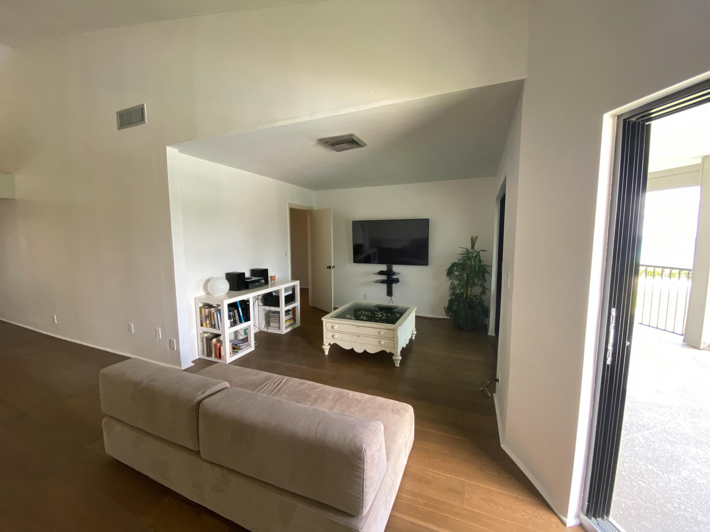 5801 North Ocean Boulevard, Unit 208 Ocean Ridge, FL 33435 - Photo 5 of 7 a bedroom with furniture and a flat screen tv