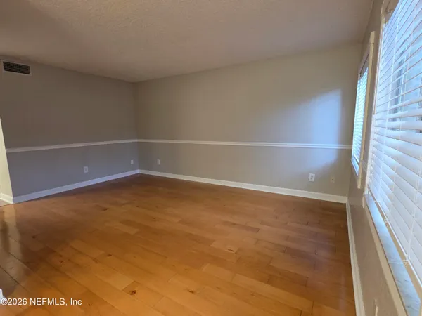 a kitchen with granite countertop white cabinets and a sink