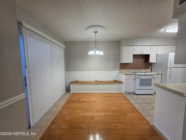 an empty room with a window and a ceiling fan