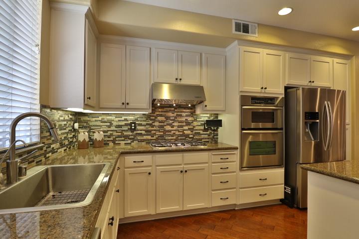 6372 Byron Lane San Ramon, CA 94582 - Photo 18 of 53 a kitchen with stainless steel appliances granite countertop a sink a stove and refrigerator