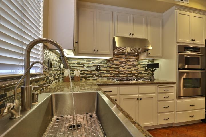 6372 Byron Lane San Ramon, CA 94582 - Photo 19 of 53 a kitchen with stainless steel appliances kitchen island granite countertop a stove a sink and a microwave