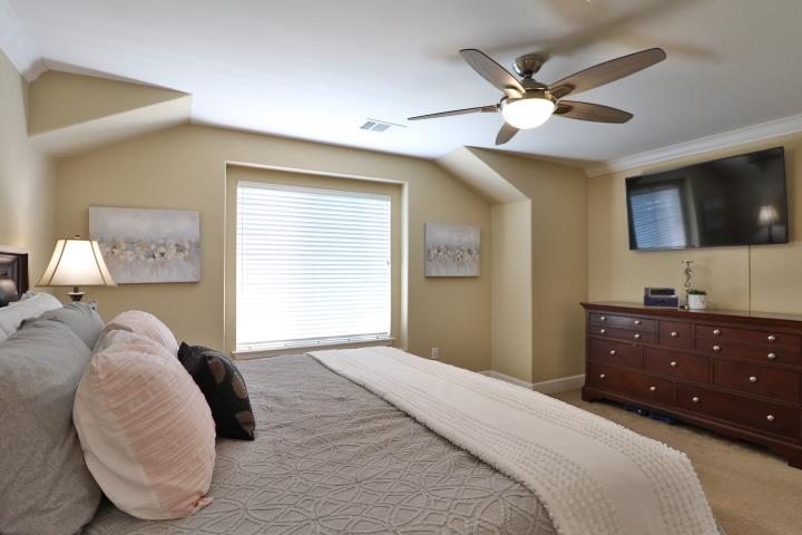 6372 Byron Lane San Ramon, CA 94582 - Photo 35 of 53 a bedroom with a large bed and a flat screen tv