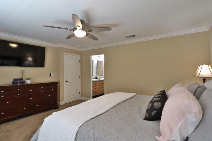 6372 Byron Lane San Ramon, CA 94582 - Photo 36 of 53 a bedroom with a bed a television and a dresser with the bookshelf