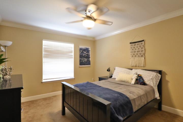 6372 Byron Lane San Ramon, CA 94582 - Photo 43 of 53 a bedroom with a bed and a chandelier