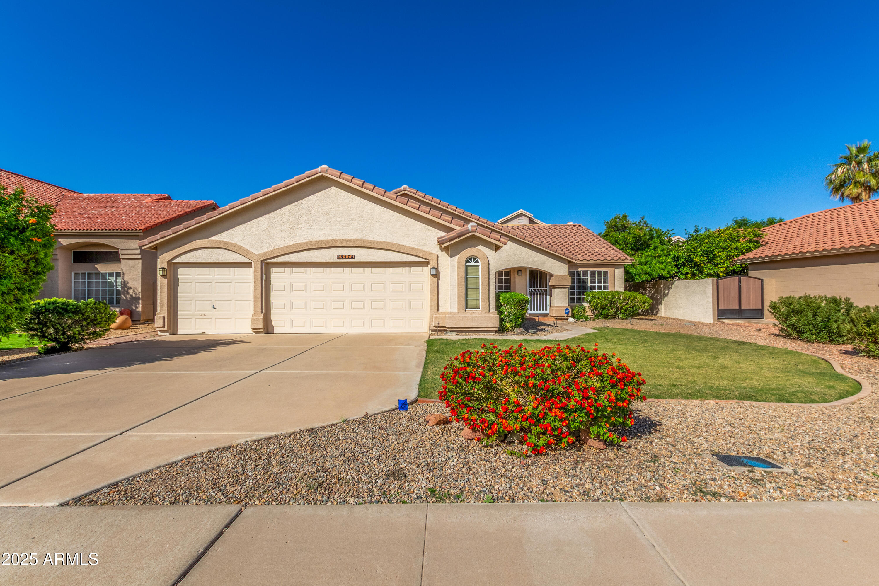 a front view of a house with a garden