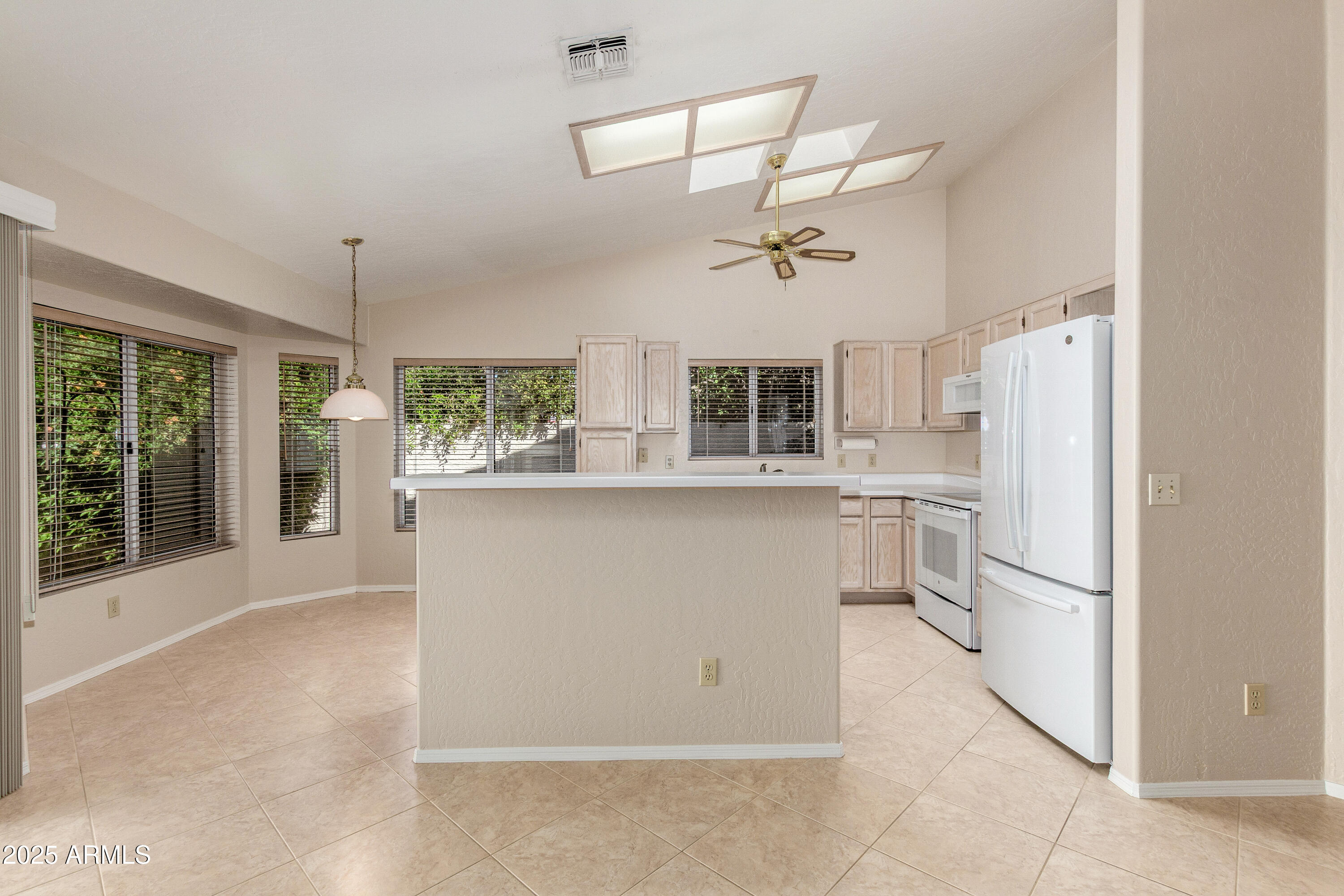 8578 South Maple Avenue Tempe, AZ 85284 - Photo 12 of 28 a kitchen with stainless steel appliances kitchen island a refrigerator sink and cabinets