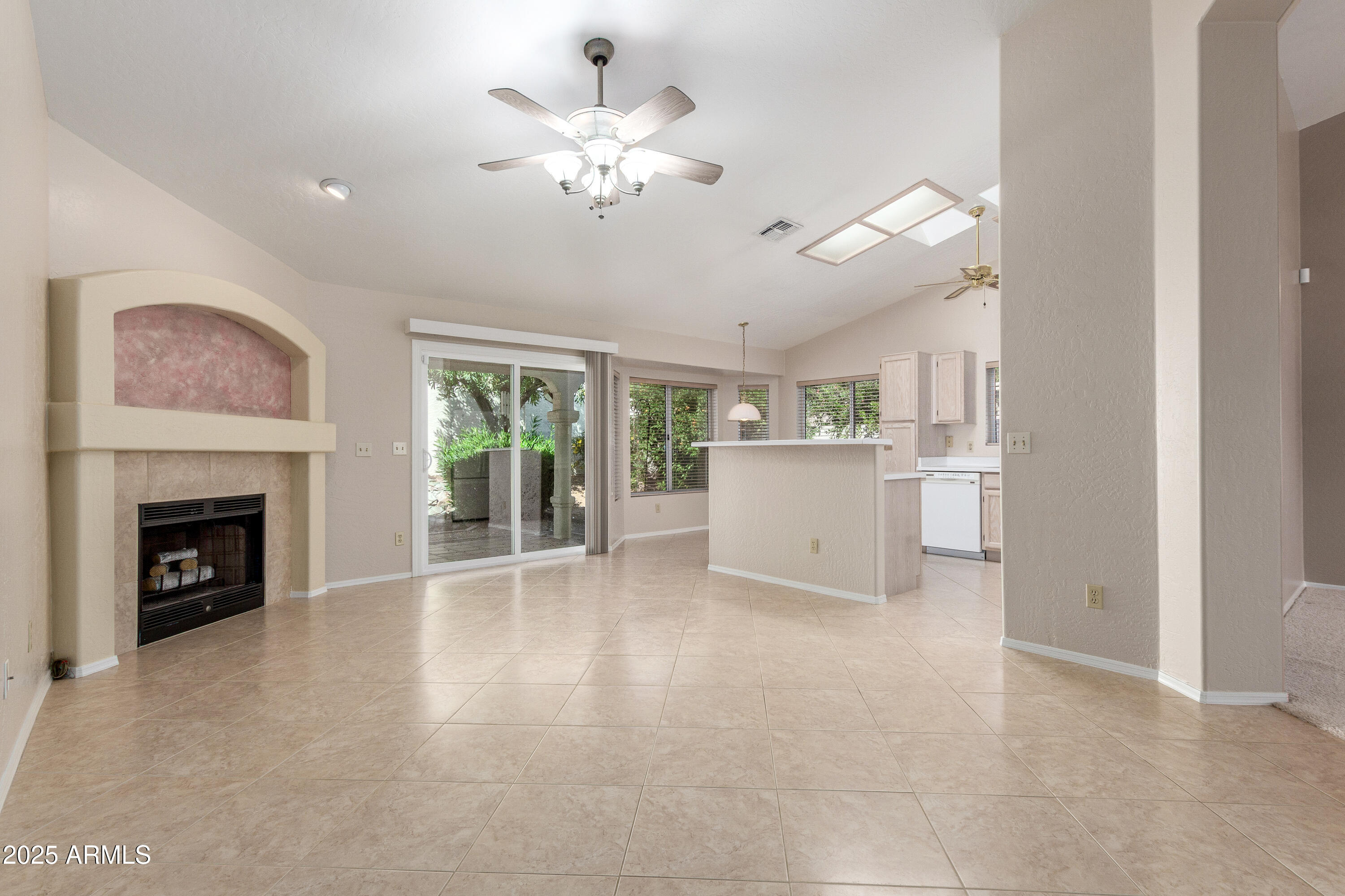 8578 South Maple Avenue Tempe, AZ 85284 - Photo 6 of 28 a view of a livingroom with a fireplace a chandelier and windows