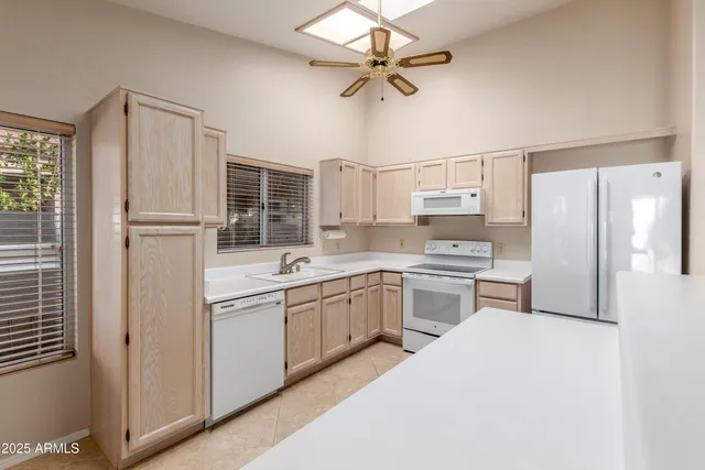 a kitchen with a sink stainless steel appliances and white cabinets