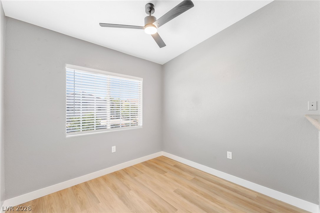 3318 North Decatur Boulevard, Unit 2152 Las Vegas, NV 89130 - Photo 10 of 58 A quiet space with sleek hardwood flooring, brightened by natural light through a wide window.
