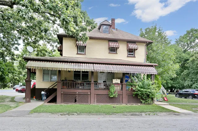 a front view of a house with a garden and plants