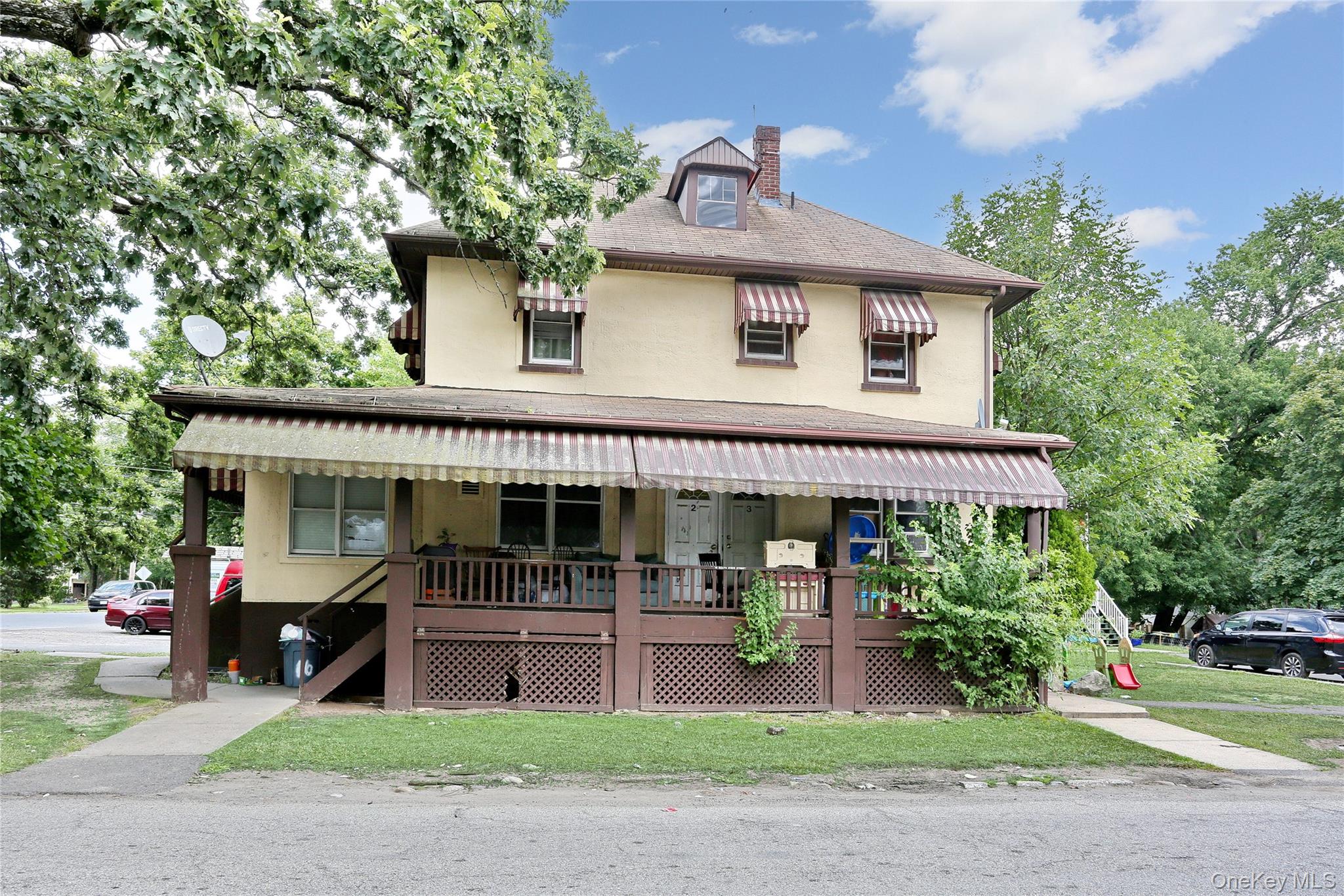 Undisclosed Address Spring Valley, NY 10977 - Photo 1 of 9 a front view of a house with a garden and plants